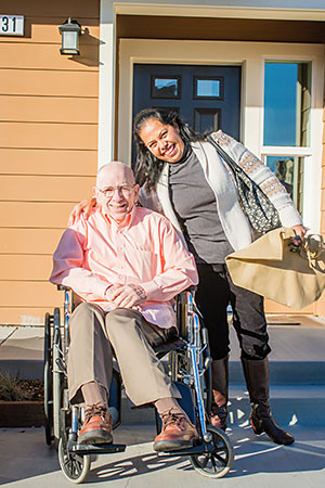 Photo of woman and elderly man smiling